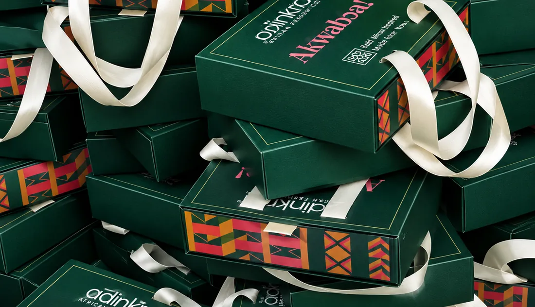 Adinkra printed gift boxes with ribbon, stacked.