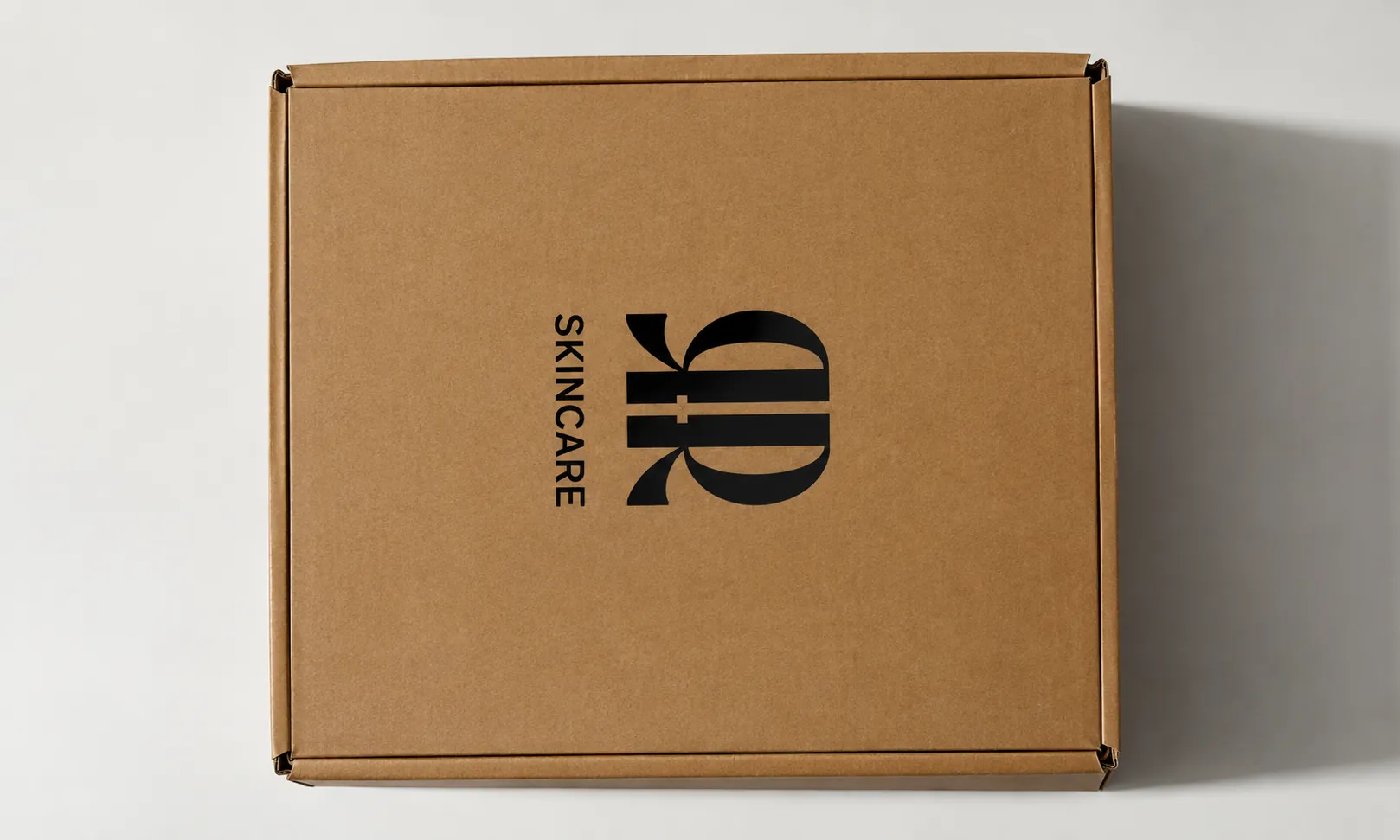 Rigid lid boxes wrapped in ivory paper, stacked.